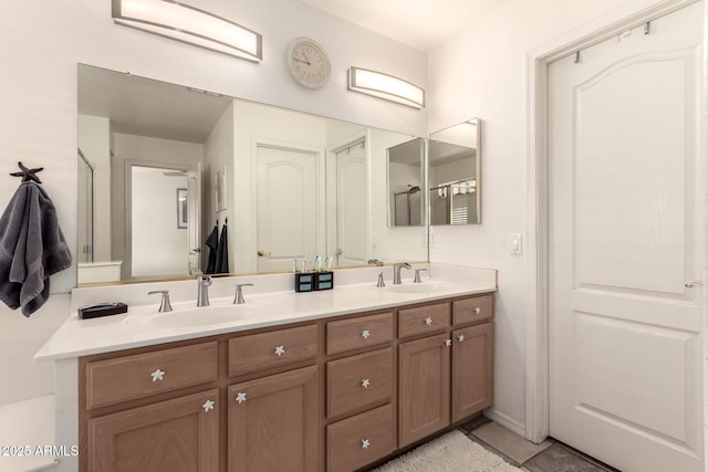 bathroom featuring tile patterned floors, a sink, and double vanity