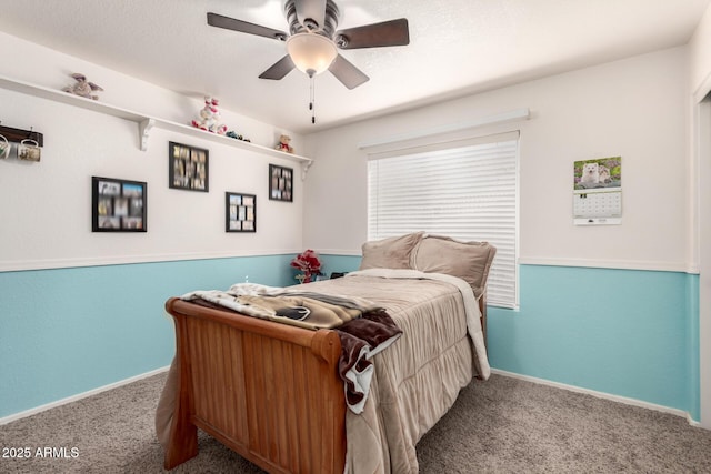 carpeted bedroom with a ceiling fan, a textured ceiling, and baseboards