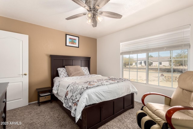 carpeted bedroom with ceiling fan and baseboards