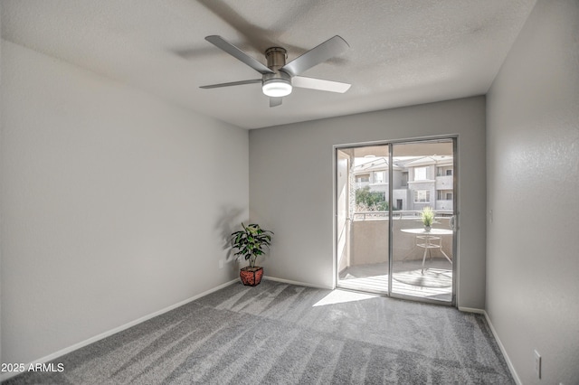 carpeted spare room with ceiling fan and a textured ceiling