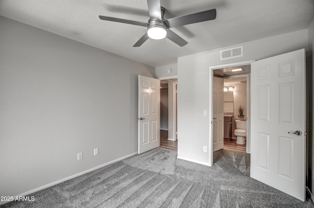 unfurnished bedroom featuring a textured ceiling, ceiling fan, and carpet flooring