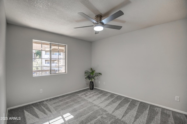 carpeted empty room with ceiling fan and a textured ceiling