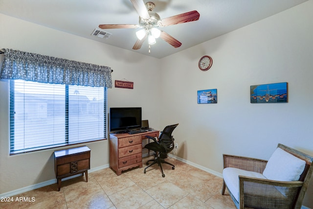 tiled office space featuring ceiling fan