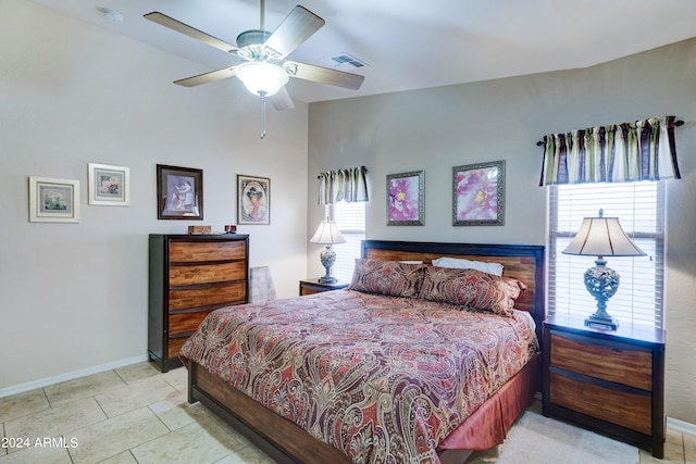 tiled bedroom featuring ceiling fan