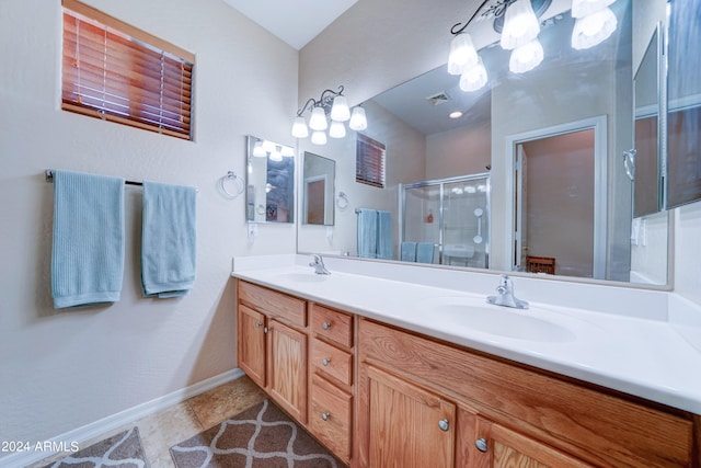 bathroom featuring walk in shower, vanity, and tile patterned floors