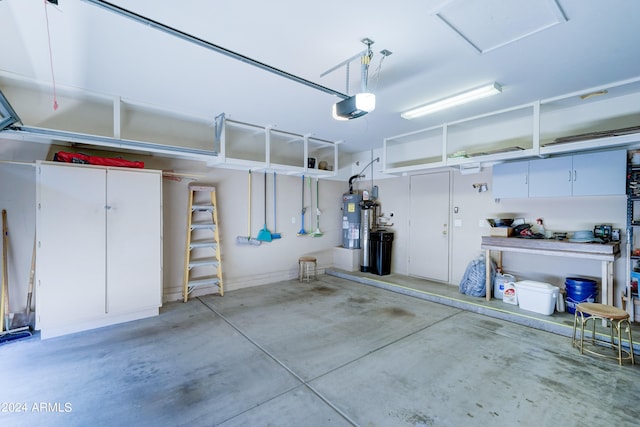 garage with water heater and a garage door opener