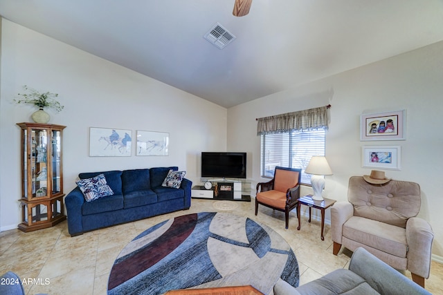 tiled living room with ceiling fan and vaulted ceiling