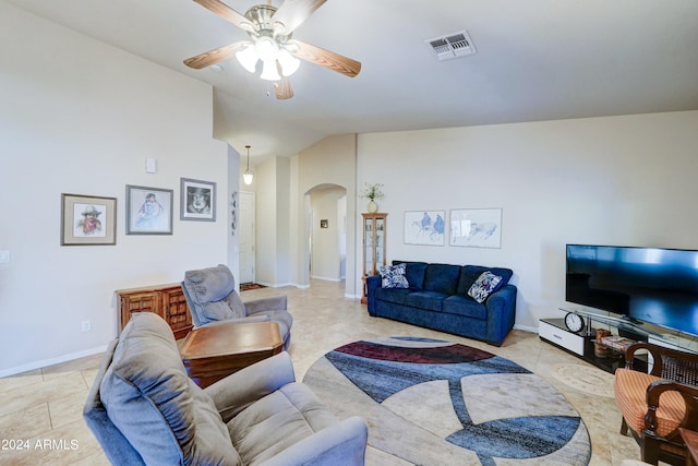 living room featuring ceiling fan, vaulted ceiling, and light tile patterned floors