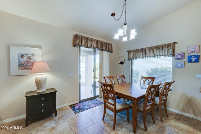 dining room with light tile patterned floors, lofted ceiling, a healthy amount of sunlight, and an inviting chandelier