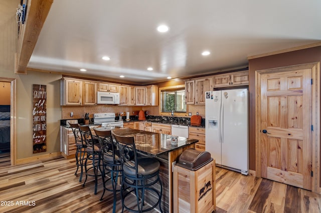 3334 Sawmill Ridge Loop, Heber, AZ 85928 - kitchen with white appliances, light wood-style flooring, a breakfast bar, recessed lighting, and tasteful backsplash