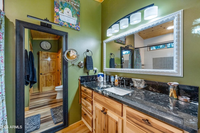 3334 Sawmill Ridge Loop, Heber, AZ 85928 - bathroom with toilet, wood finished floors, vanity, and a shower with shower curtain