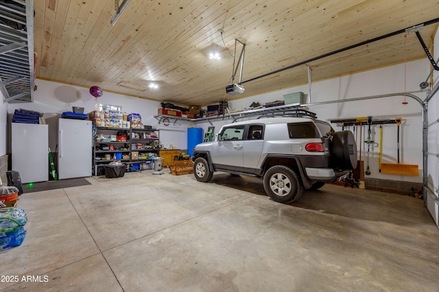 3334 Sawmill Ridge Loop, Heber, AZ 85928 - garage featuring a garage door opener and freestanding refrigerator