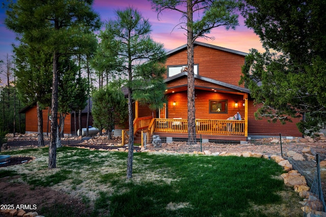 3334 Sawmill Ridge Loop, Heber, AZ 85928 - back of property at dusk featuring a lawn