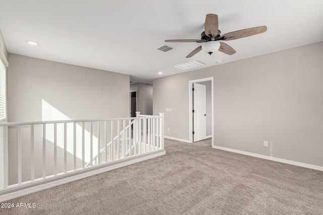 carpeted empty room featuring ceiling fan