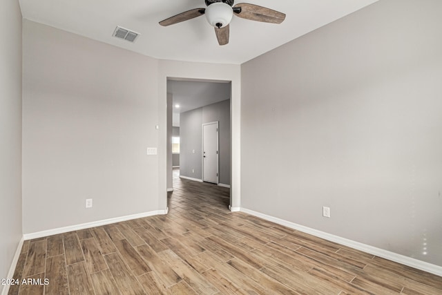 spare room featuring light hardwood / wood-style flooring and ceiling fan