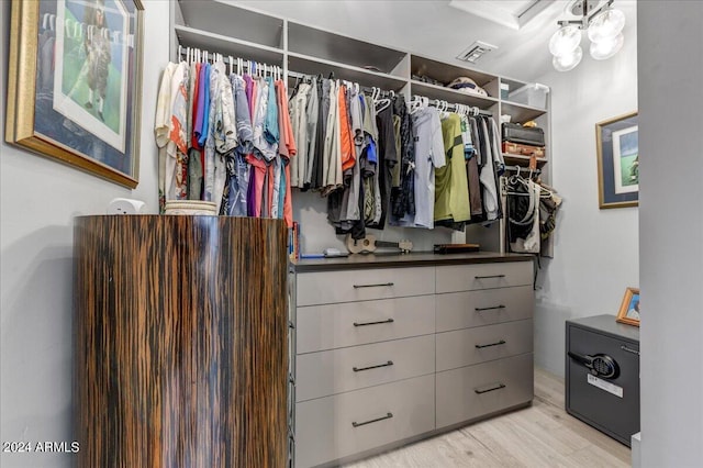 walk in closet featuring light hardwood / wood-style flooring