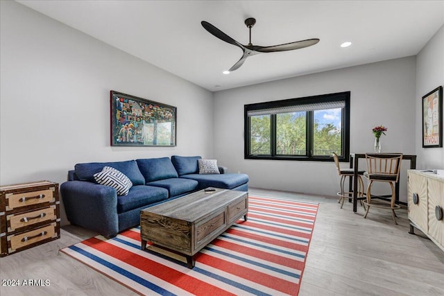 living room featuring ceiling fan and hardwood / wood-style flooring