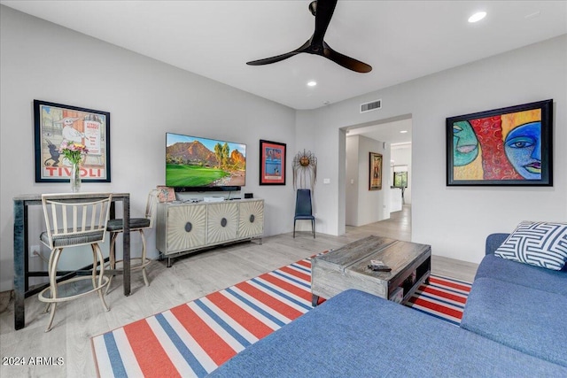 living room featuring ceiling fan and hardwood / wood-style floors