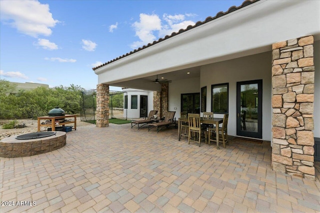 view of patio with an outdoor fire pit and ceiling fan