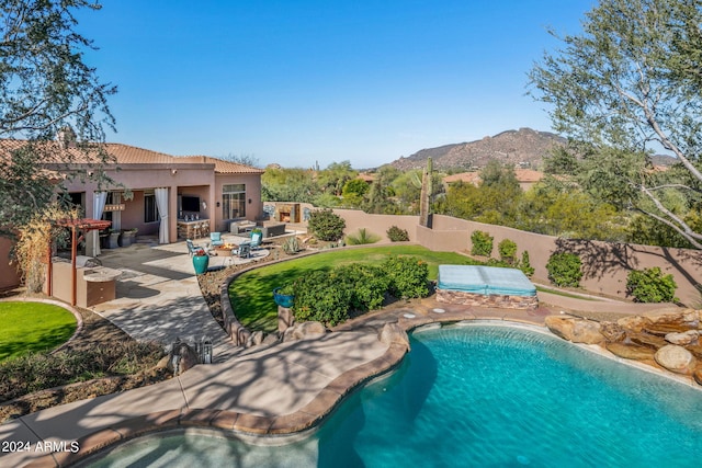 view of pool with a patio and a mountain view