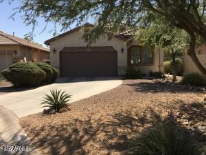 view of front of home featuring a garage, driveway, and stucco siding