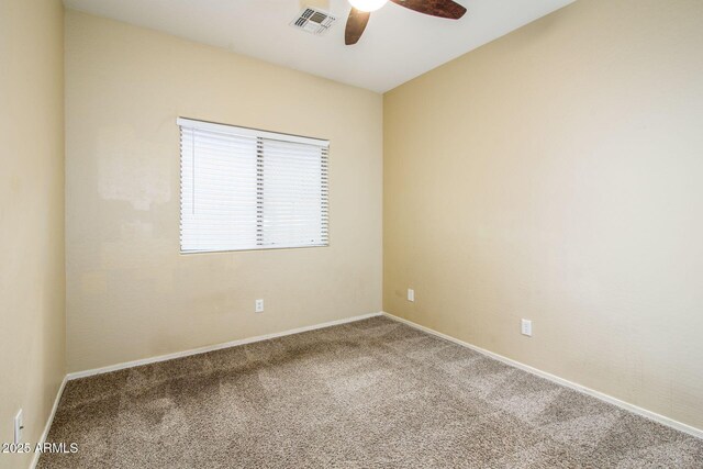 unfurnished room featuring carpet flooring, a ceiling fan, visible vents, and baseboards
