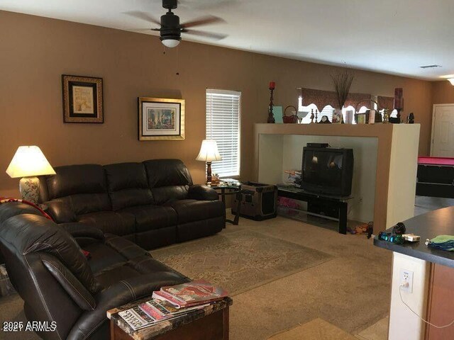 living room with carpet and a ceiling fan
