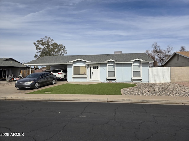 single story home featuring a front lawn and a carport