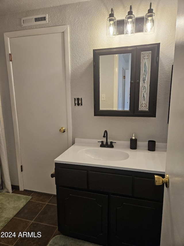 bathroom featuring tile patterned floors and vanity