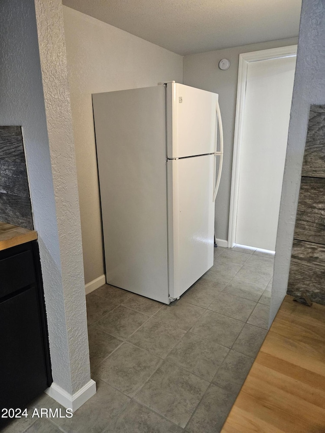 kitchen with white refrigerator and light tile patterned floors