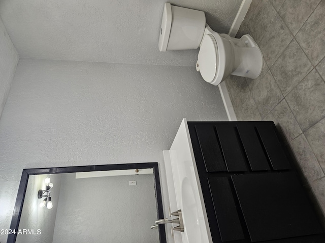 bathroom featuring toilet and a textured ceiling