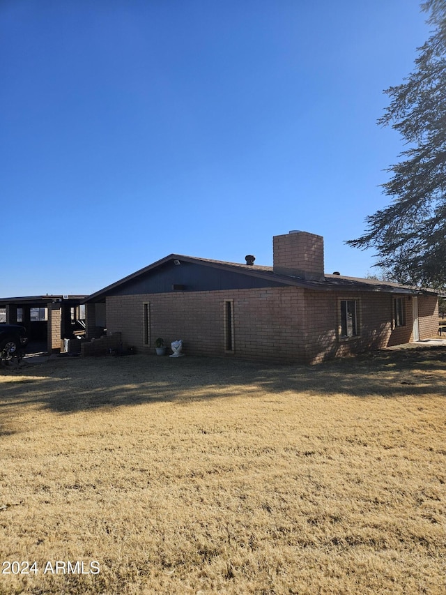 back of house with a lawn