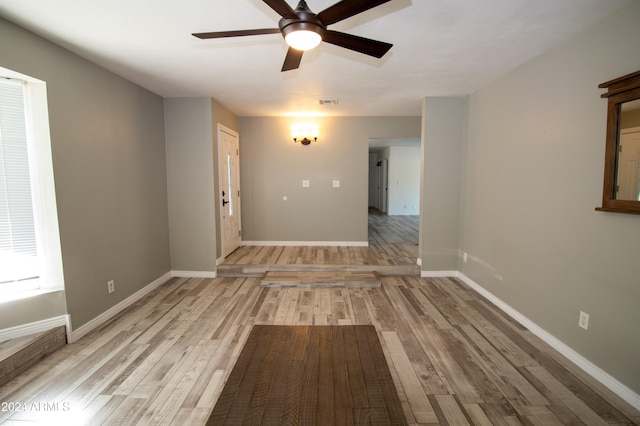 empty room featuring ceiling fan and light hardwood / wood-style floors