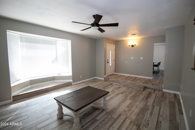 unfurnished living room with light hardwood / wood-style flooring and ceiling fan