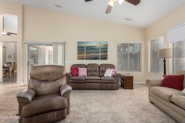 living room with vaulted ceiling, light tile patterned flooring, and ceiling fan