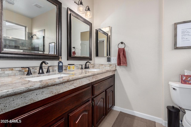 bathroom featuring walk in shower, vanity, toilet, and tile patterned flooring