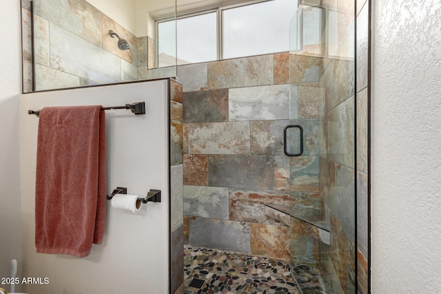 bathroom with a shower with door