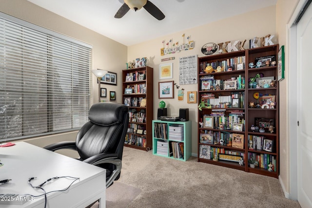 carpeted home office with ceiling fan