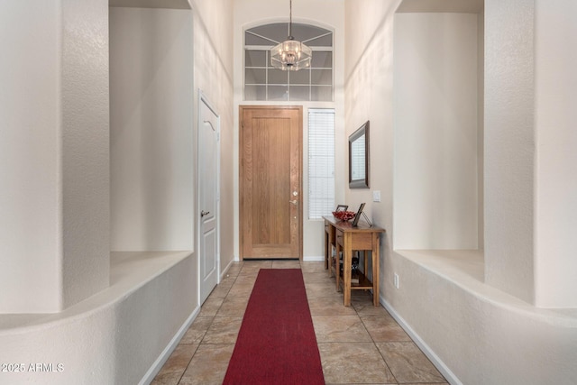 doorway featuring light tile patterned floors and a chandelier