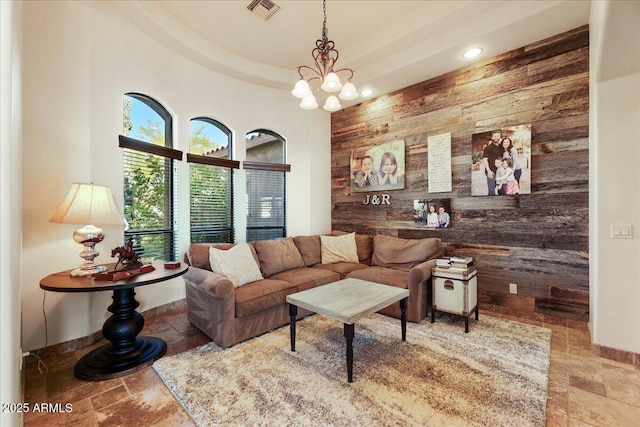 28025 N 156th Pl, Scottsdale, AZ 85262 - living room featuring stone tile flooring, wooden walls, baseboards, a chandelier, and recessed lighting