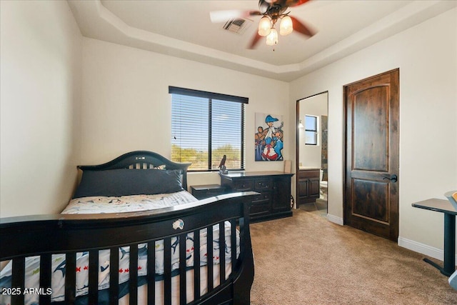 28025 N 156th Pl, Scottsdale, AZ 85262 - bedroom with light carpet, a tray ceiling, ensuite bathroom, and baseboards