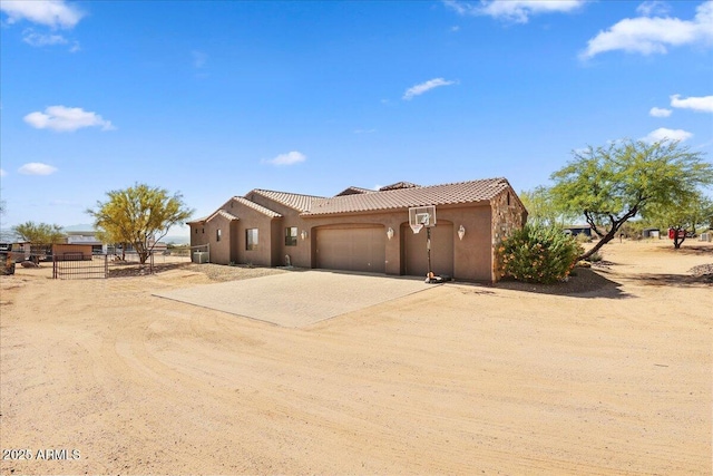 28025 N 156th Pl, Scottsdale, AZ 85262 - view of front of house with dirt driveway, a tiled roof, stucco siding, and a garage