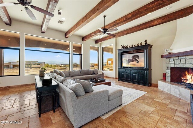 28025 N 156th Pl, Scottsdale, AZ 85262 - living room with a ceiling fan, stone tile flooring, a stone fireplace, and beamed ceiling