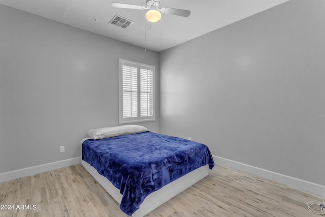 bedroom with ceiling fan and light hardwood / wood-style flooring