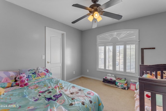 bedroom featuring ceiling fan and light carpet