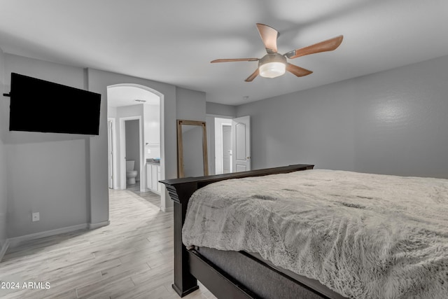 bedroom featuring light hardwood / wood-style flooring, connected bathroom, and ceiling fan