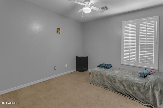 unfurnished bedroom featuring light colored carpet, ceiling fan, and a closet