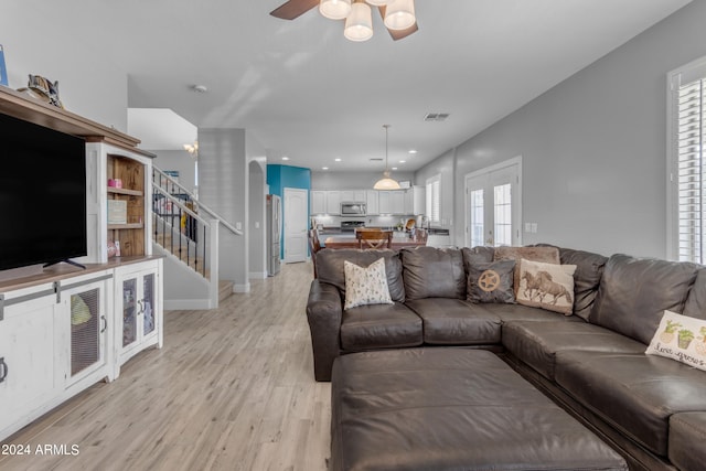 living room featuring ceiling fan and light hardwood / wood-style floors