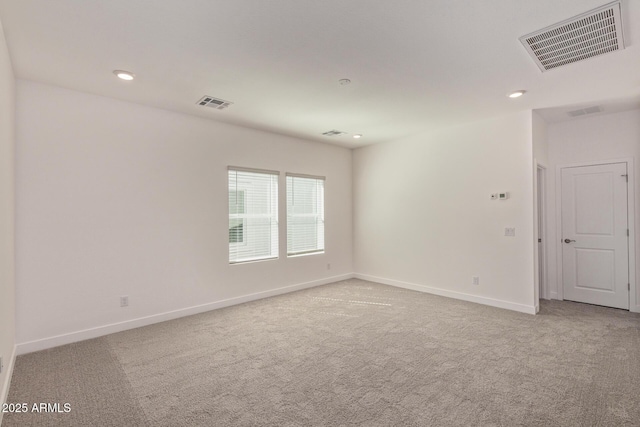 carpeted spare room with baseboards, visible vents, and recessed lighting