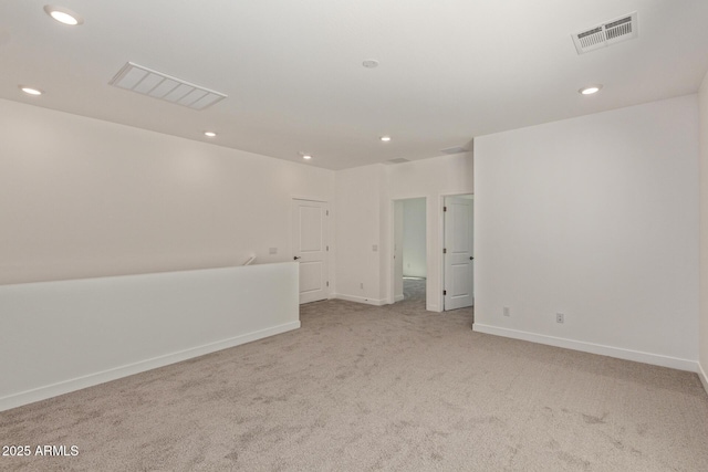 spare room featuring recessed lighting, carpet, visible vents, and baseboards